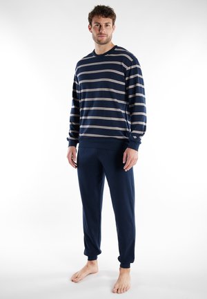 Navy striped pullover with long sleeves and crew neck; paired with matching navy sweatpants featuring elastic cuffs and side pockets.