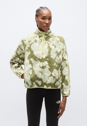 Pullover in pile verde con un motivo tie-dye chiaro e tenue, dotato di una zip a un quarto e polsini a costine. Decorato con un logo.