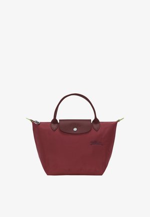 Maroon tote bag made of nylon with leather accents, featuring a snap closure, dual handles, and a contrasting green zipper pull.