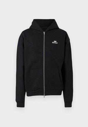 Črna trenirka z zadrgo, sprednjima žepoma in majhnim belim logotipom "bareen" na levi strani prsnega koša, prikazana na enostavni podlagi.