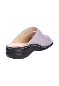 Lavender open-back slip-on sandal with cushioned beige insole and thick black sole, angled to show interior and stitching detail.