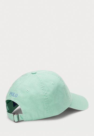 Mint green cotton baseball cap with a curved visor, adjustable strap, and embroidered "POLO" logo on the back. Smooth texture, simple design.