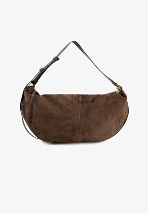 Brun ruskinds skuldertaske i halvmåneform med justerbar mørk læderrem og lille guldcharme nær lynlås-lukningen.