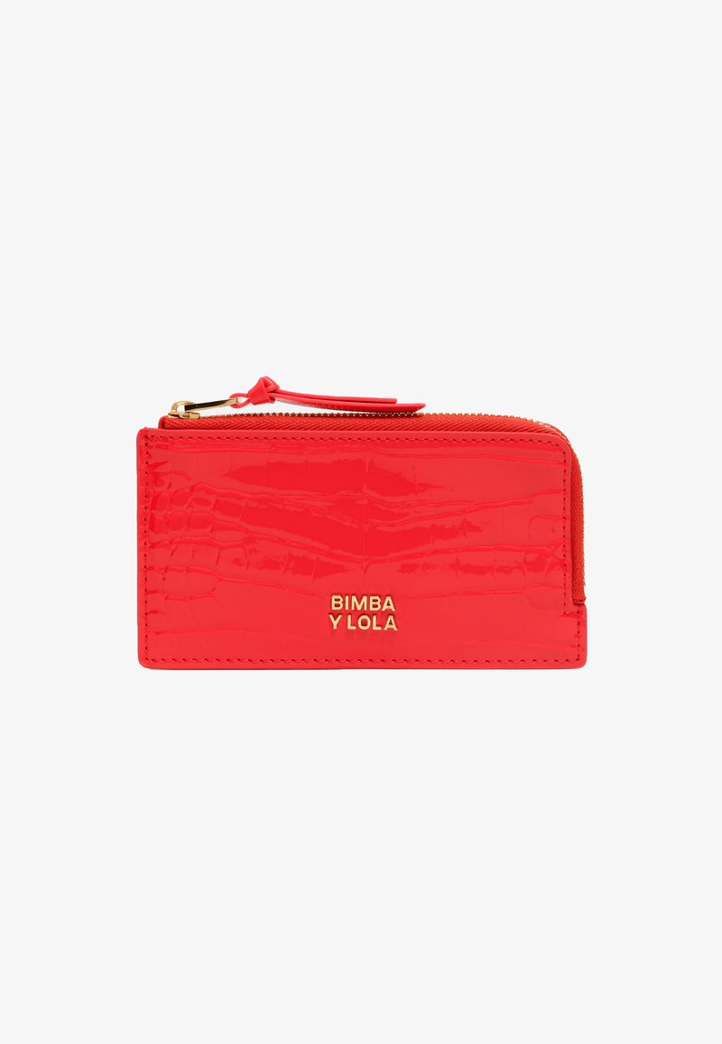 Red patent leather wallet with a crocodile texture, gold logo, and a zippered closure. Features a small strap attached to the zipper.