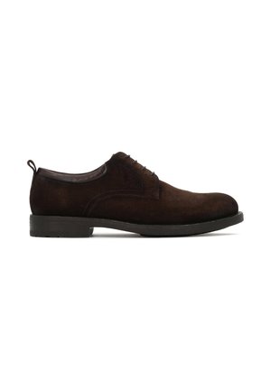 Dark brown suede men's lace-up dress shoe with low heel and rounded toe, shown in side profile on white background.