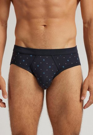 Marineblaue Baumwollslips mit einem weißen und blauen Punktmuster; elastischer Bund; enge Passform; leichtes Material; glatte Textur.