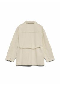 Beežipruun pikkade varrukatega jakk kraega, nähtavate õmblustega ja horisontaalse kangadetailiga selja taga, laotatud valgel taustal.