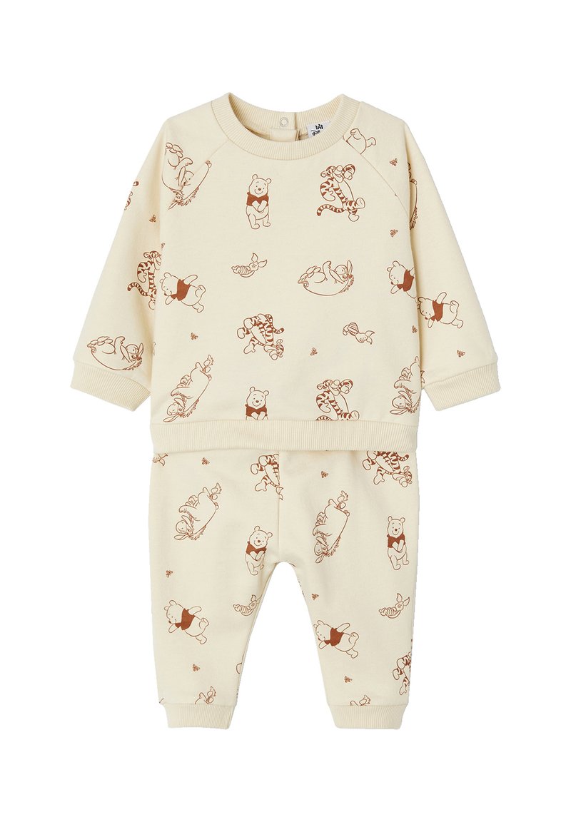 Beige Sweatshirt- und Hosen-Set mit einem Allover-Druck von Winnie Puuh und seinen Freunden in Brauntönen. Weicher Stoff, gerippte Bündchen.