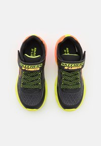 Black athletic shoes with orange and neon green accents, mesh uppers, padded collars, and textured outsoles. Adjustable strap and laces.