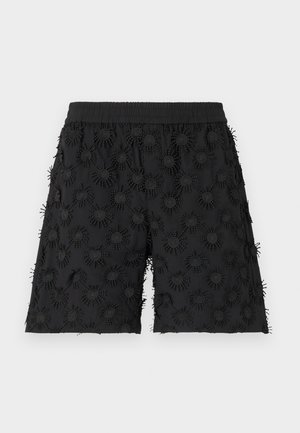 Black shorts featuring an elastic waistband, embellished with textured circular patterns and embroidery, creating a three-dimensional effect.