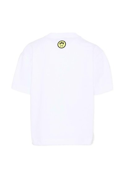 Biały t-shirt z krótkim rękawem, z małym żółtym kółkiem z czarną kreskówkową twarzą i kłami na środku górnej części pleców.