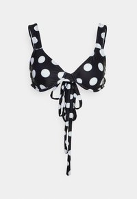 Top de bikini preto com grandes bolinhas brancas, apresentando alças de ombro ajustáveis e um laço frontal para um fecho seguro.
