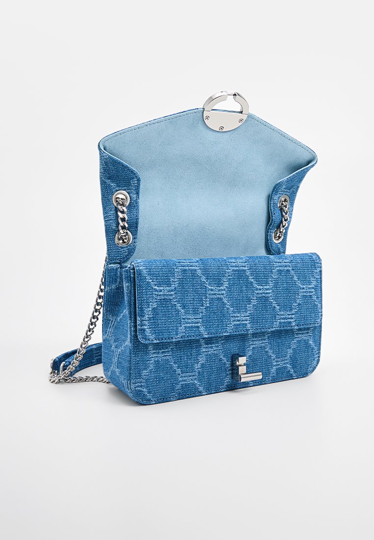 Blue patterned handbag with a textured fabric exterior, silver chain strap, and a magnetic closure, featuring a flap and a subtle brand accent.
