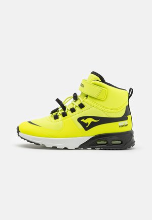 Water-resistant yellow high-top sneaker with black accents, padded collar, lace closure, and air cushion sole for enhanced comfort.