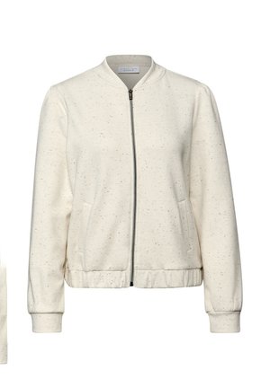 Jasnorozowa kurtka typu bomber z zamkiem z przodu, ściągaczami na mankietach, bocznymi kieszeniami i subtelną nakrapianą fakturą. Miękki materiał z elastycznym ściągaczem na dole.