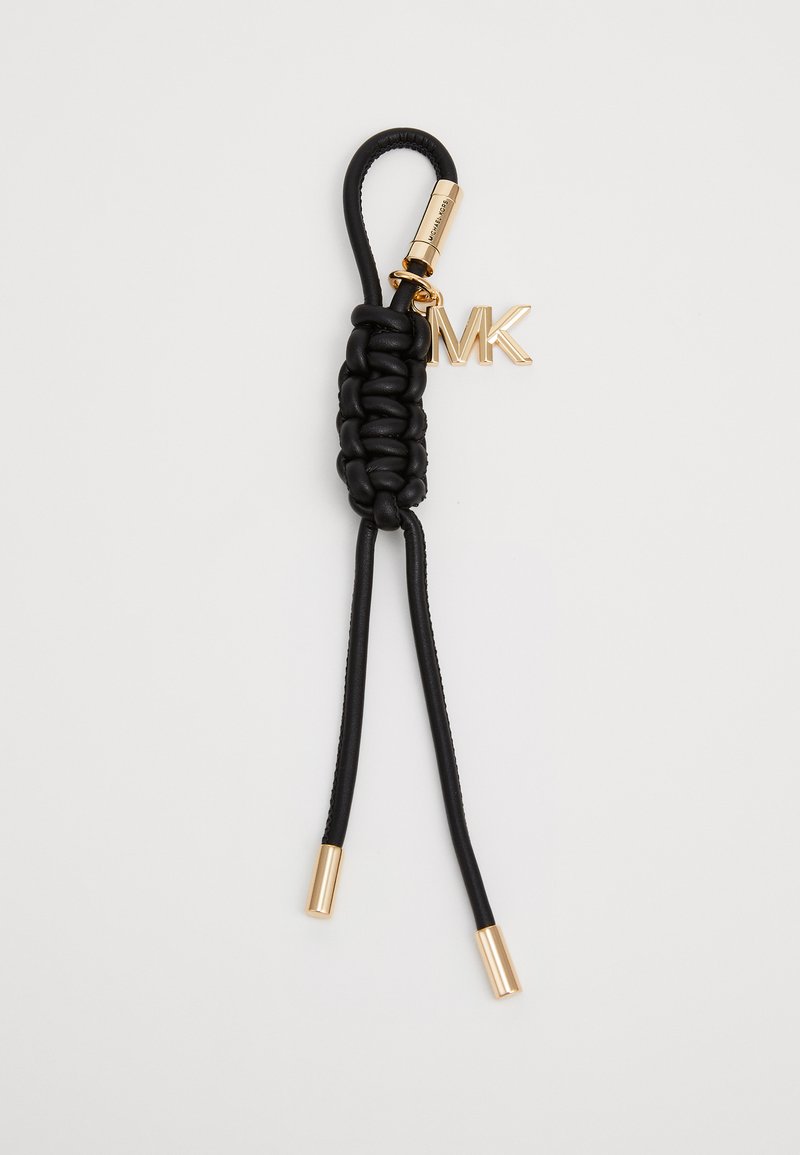 Porte-clés en cuir noir avec un centre tressé, des accents métalliques dorés et un charme logo "MK". Deux fines sangles en cuir noir s'étendent depuis la base.