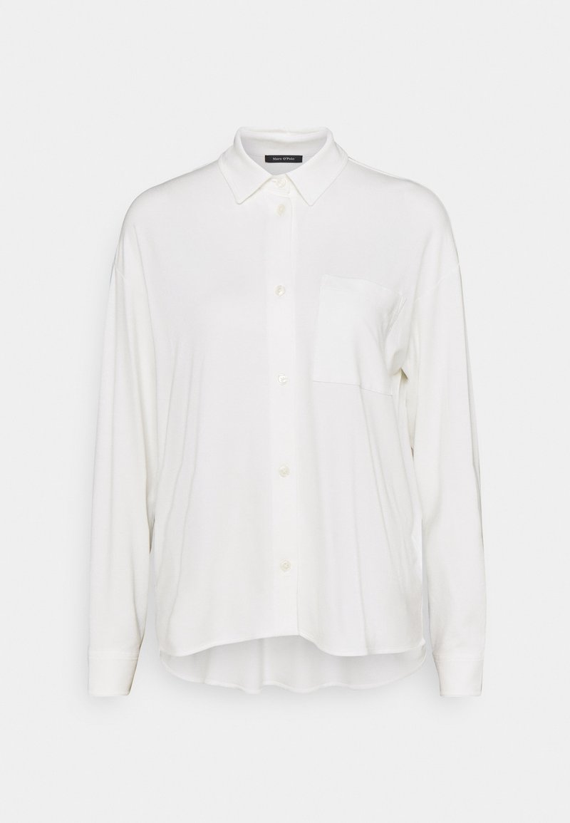 Chemise blanche à manches longues avec boutons, col et poche poitrine, coupe décontractée, ourlet arrière légèrement plus long.
