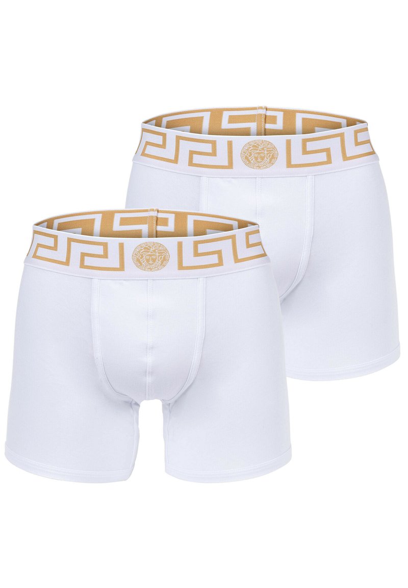 White boxer briefs with a gold pattern waistband, featuring a Greek key design and a logo accent. Made from soft, stretchy fabric.