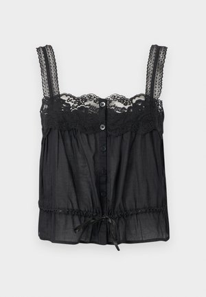 Μαύρο αμάνικο τοπ με δαντέλα στα λουριά και το ντεκολτέ, κουμπιά μπροστά και κορδόνι στη μέση, σε απλό φόντο.