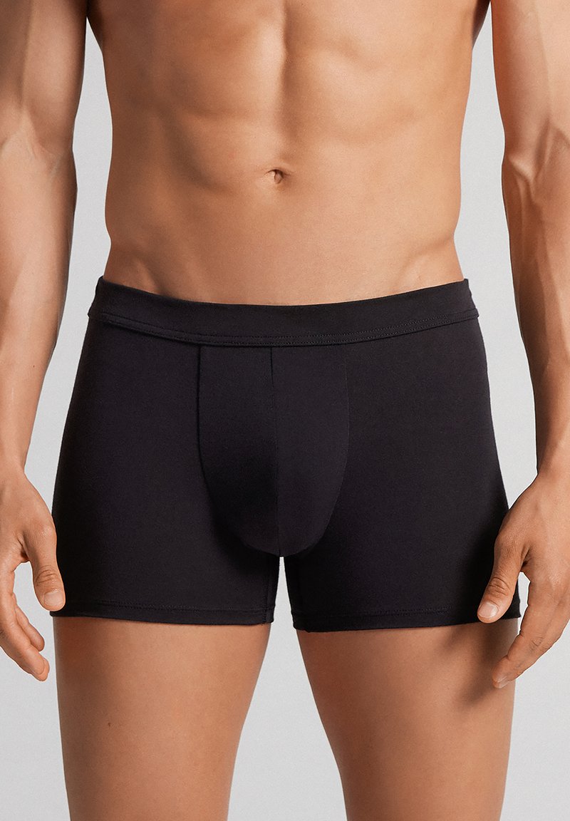 Zwarte boxershorts van elastische stof; aansluitend ontwerp met een soepele tailleband, met een gevormde pouch aan de voorkant.