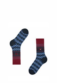 Chaussettes multicolores avec un motif floral bleu sur un fond sombre, avec des accents bordeaux au niveau du poignet et du pied, et un tissu texturé.