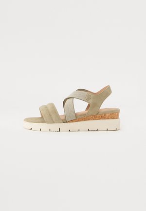 Light green suede wedge sandals with crisscross elastic straps, cork accents, and a textured rubber sole for grip.
