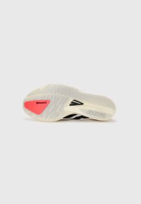 Black and white athletic shoe outsole with a translucent design, featuring a red Continental logo and textured tread patterns. ADIZERO branding visible.