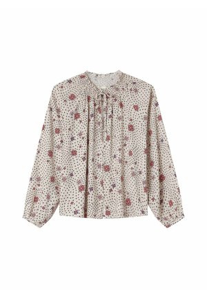 Blouse à motif floral avec des manches longues, encolure froncée et fond beige clair. Présente des fleurs rouges et violettes ainsi qu'un tissu texturé.
