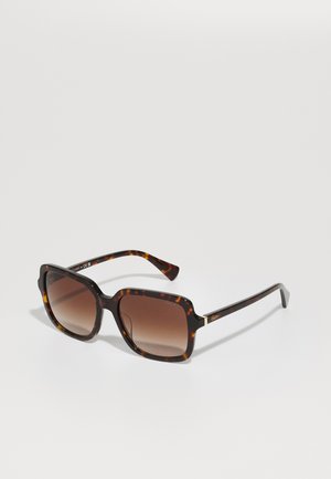 Brown tortoiseshell sunglasses with a square shape, gradient brown lenses, and slender temples featuring subtle branding and metallic accents.