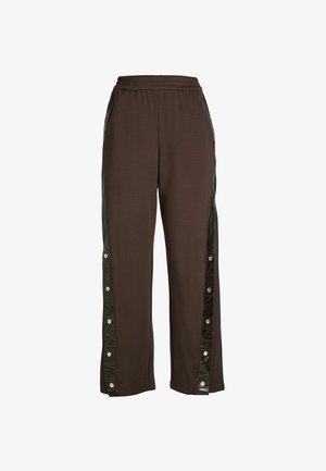 Brune afslappede bukser med elastisk talje, der har sorte side-striber med trykknapper langs benene.