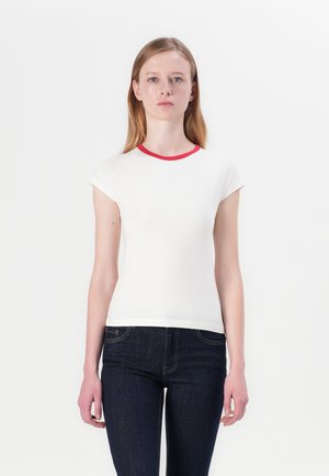 White short-sleeve t-shirt with a red ribbed neckline, featuring a fitted design. Worn with dark denim jeans, no visible patterns or graphics.