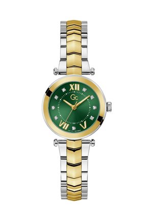 Kuld- ja hõbetooniline kell, millel on ümmargune roheline kellanägu, Rooma numbrid, teemantaktsendid ja kahetooniline link-ripatsidisain.