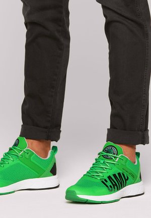 Green athletic shoes featuring a mesh upper, black accents, and white sole. Notable branding on the side and a padded collar for comfort.