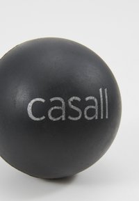 Black massage ball with a smooth texture, featuring the word "casall" in silver lettering along the side.