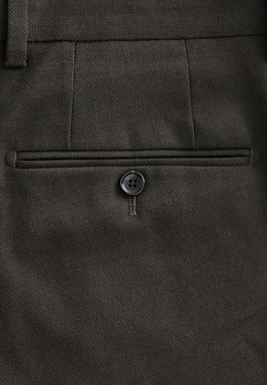Dark brown trousers featuring a back pocket with a button closure, textured fabric, and a subtle diagonal pattern.