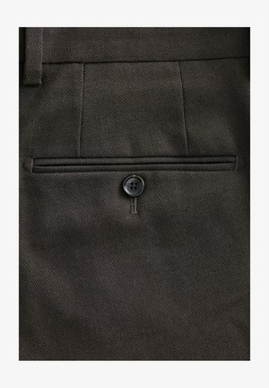 Dark brown trousers featuring a back pocket with a button closure, textured fabric, and a subtle diagonal pattern.