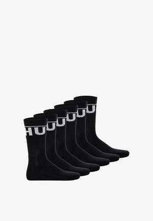 Schwarze Baumwollsocken im Set von sechs, mit geripptem Textur und einem kontrastierenden weißen Logo-Band oben. Standard Crew-Länge Design.