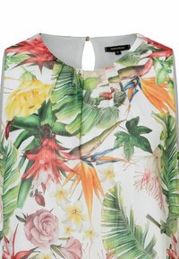 Blumenbluse aus leichtem, transparenter Material mit lebhaften Mustern von tropischen Blättern und Blumen in Grün, Gelb, Rot und Pink.