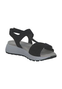 Zwarte suede sandalen met kruislingse banden, open teen en een witte textuurzool. Beschikt over een flexibele rubberen buitenzool voor comfort.
