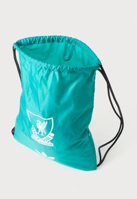Teal krāsu saisto�ša soma, izgatavota no viegla auduma, ar baltu Liverpūles futbola kluba logo un melnām auklām aizsardzībai.