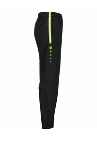 Zwarte sportbroek met een slim fit, voorzien van heldergele accenten en zijzakken. Ritsen bij de enkels voor gemakkelijk aan- en uittrekken.
