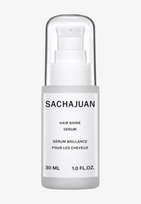 Klart glass pumpeflaske med sølvhette. Etiketten har svart tekst på hvit bakgrunn. Inneholder 30 ml hårskinnserum.