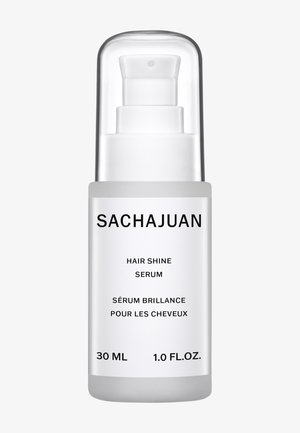 Klart glass pumpeflaske med sølvhette. Etiketten har svart tekst på hvit bakgrunn. Inneholder 30 ml hårskinnserum.