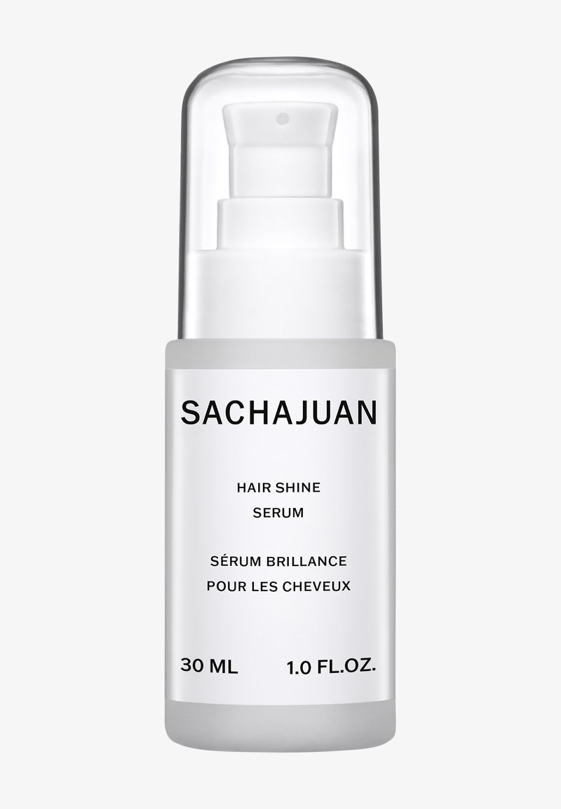 Klart glass pumpeflaske med sølvhette. Etiketten har svart tekst på hvit bakgrunn. Inneholder 30 ml hårskinnserum.