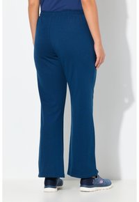 Marineblaue Schlaghose mit elastischem Bund, aus weichem Stoff, mit glatter Textur und angenehm lockerem Sitz.