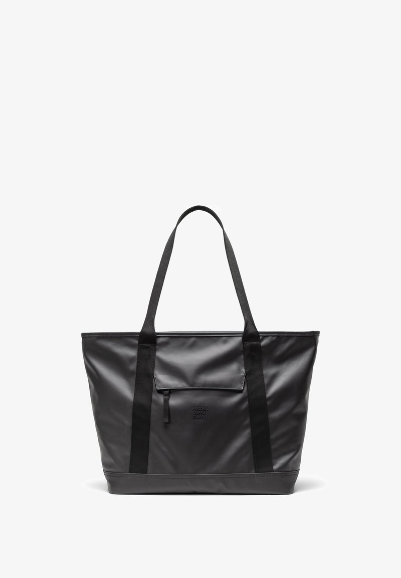Black tote bag made of smooth, durable material with two long straps, a front pocket, and embossed branding. Rectangular shape with a flat base.