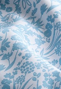 Pamut szövet világoskék virágmintával fehér alapon, texturált szövésű és bonyolult botanikus mintázatú.