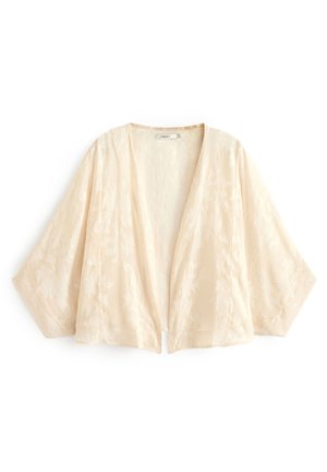 Veste courte crème de style kimono avec manches larges et motif floral subtil, devant ouvert, tissu léger.