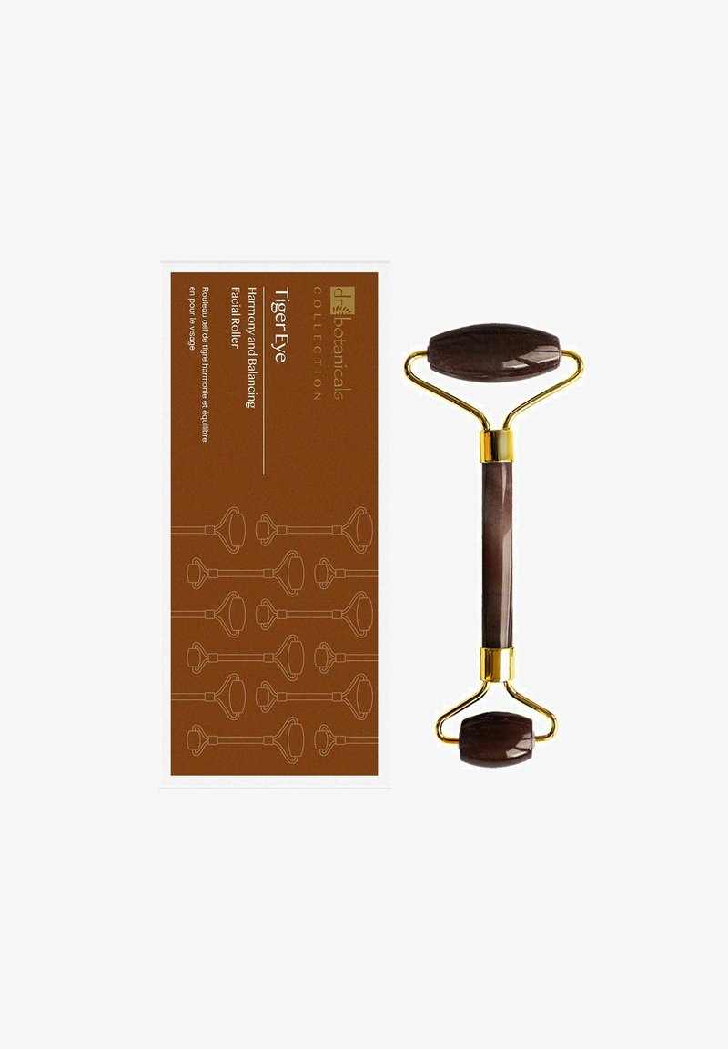 Tiger eye facial roller with polished stone rollers and gold metal frame, displayed next to brown packaging labeled for harmony and balancing.