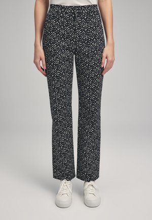 Schwarz-weiße gepunktete Hose mit geradem Bein, der Stoff ist glatt und der Bund betont eine taillierte Passform.